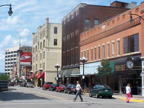 Person walking across the street in downtown area